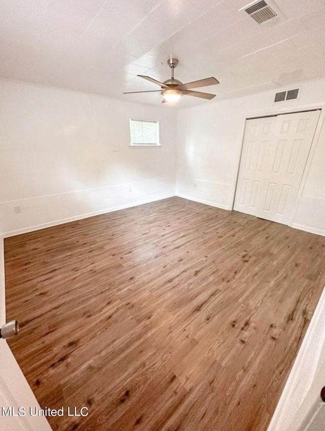 spare room with hardwood / wood-style flooring and ceiling fan