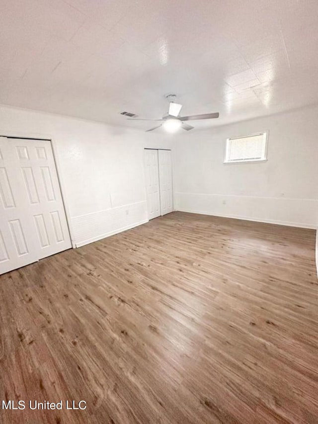 spare room featuring wood-type flooring and ceiling fan