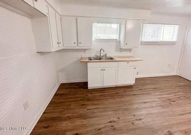 kitchen featuring white cabinets, sink, and dark hardwood / wood-style flooring