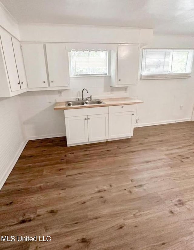 766 Monterey St A-B, Unit A-B Jackson, MS 39204 - kitchen with a sink, white cabinets, wood finished floors, and baseboards
