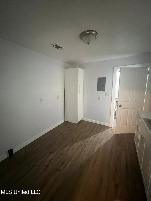 interior space with electric panel and dark hardwood / wood-style floors