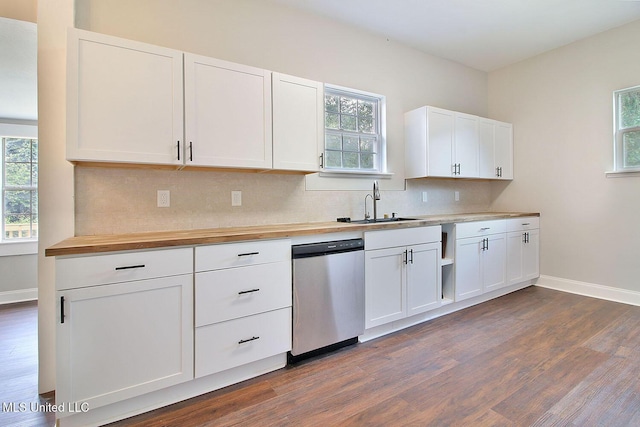 305 First Ave, New Augusta, MS 39462 - kitchen with stainless steel dishwasher, butcher block countertops, dark wood-style flooring, backsplash, and baseboards