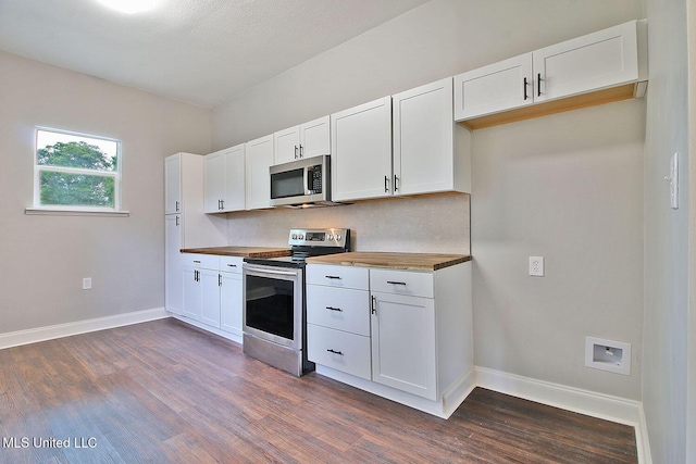 305 First Ave, New Augusta, MS 39462 - kitchen with stainless steel appliances, butcher block counters, dark wood-style flooring, and white cabinetry