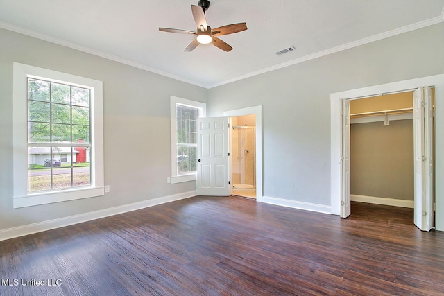 305 First Ave, New Augusta, MS 39462 - unfurnished bedroom featuring dark wood-style floors, baseboards, a spacious closet, crown molding, and connected bathroom