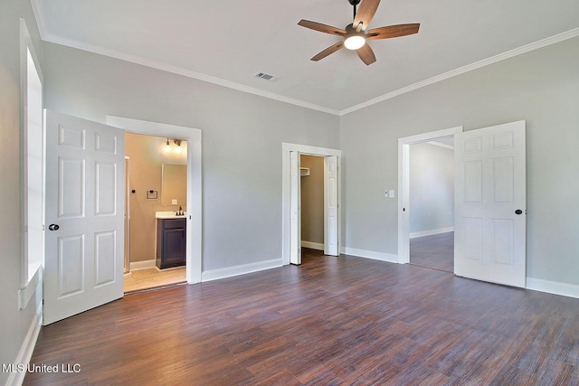 305 First Ave, New Augusta, MS 39462 - unfurnished bedroom with dark wood finished floors, crown molding, baseboards, connected bathroom, and a sink