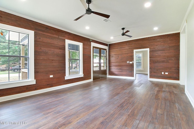 305 First Ave, New Augusta, MS 39462 - unfurnished living room with french doors, wooden walls, ornamental molding, ceiling fan, and baseboards