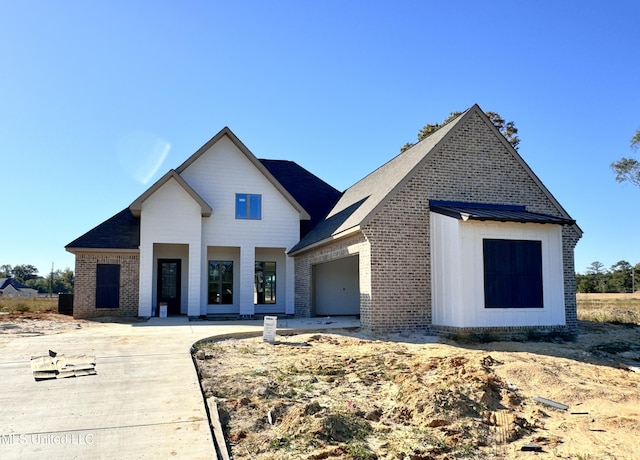 modern inspired farmhouse featuring a garage