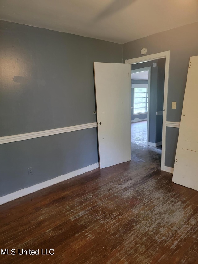 unfurnished room featuring dark hardwood / wood-style flooring