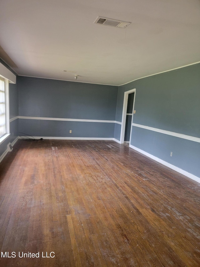 unfurnished room featuring dark wood-type flooring