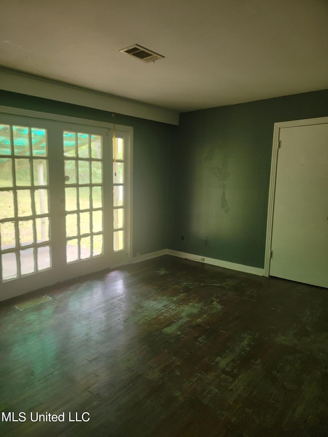 spare room with dark hardwood / wood-style flooring