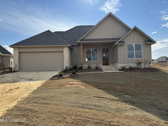 303 Birch Ct Lot 32, Canton, MS 39046 - ranch-style home with board and batten siding, brick siding, driveway, roof with shingles, and an attached garage