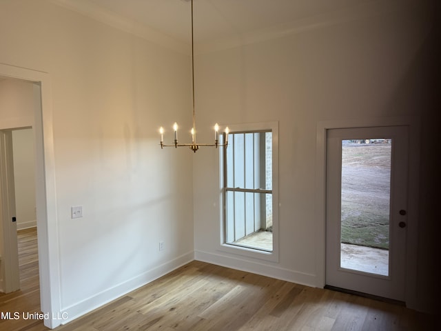303 Birch Ct Lot 32, Canton, MS 39046 - unfurnished dining area with crown molding, a notable chandelier, wood finished floors, and baseboards