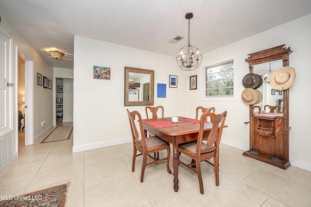 dining room featuring light tile patterned flooring and a notable chandelier