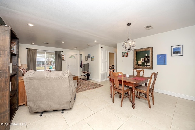 tiled dining space featuring a chandelier