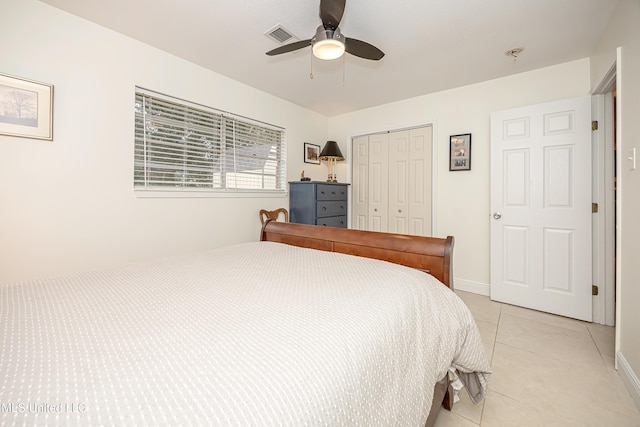 bedroom with a closet, ceiling fan, and light tile patterned flooring