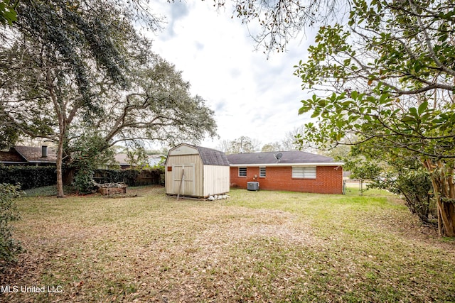 view of yard featuring central AC and a shed