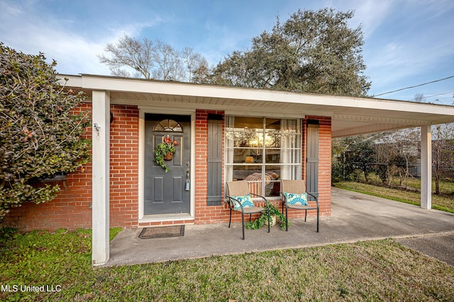 view of exterior entry featuring a carport