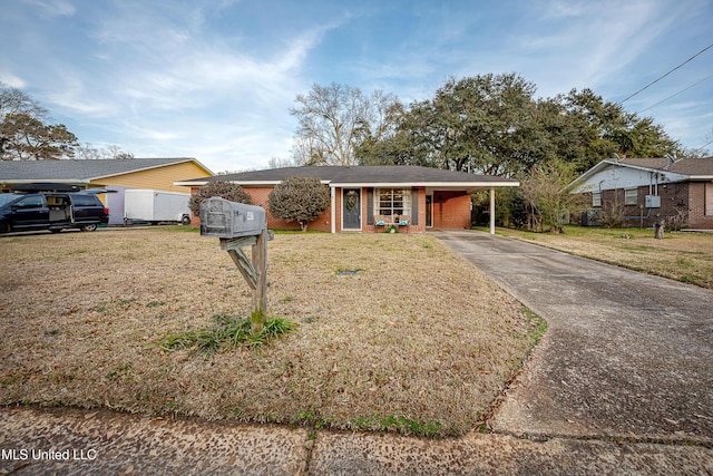 ranch-style house featuring a carport and a front lawn