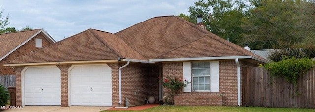 766 Whitney Dr, Biloxi, MS 39532 - view of front facade featuring an attached garage, concrete driveway, a chimney, brick siding, and a shingled roof