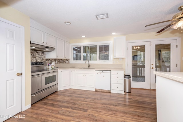 kitchen with white dishwasher, under cabinet range hood, dark wood-type flooring, white cabinetry, and double oven range