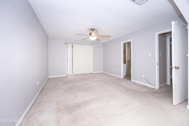 unfurnished bedroom featuring a ceiling fan, light colored carpet, and baseboards