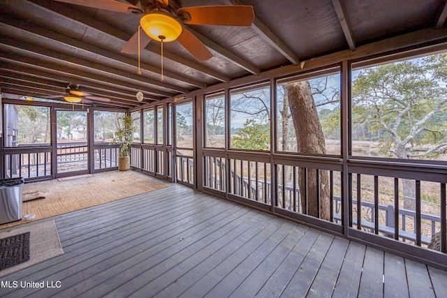 unfurnished sunroom with ceiling fan