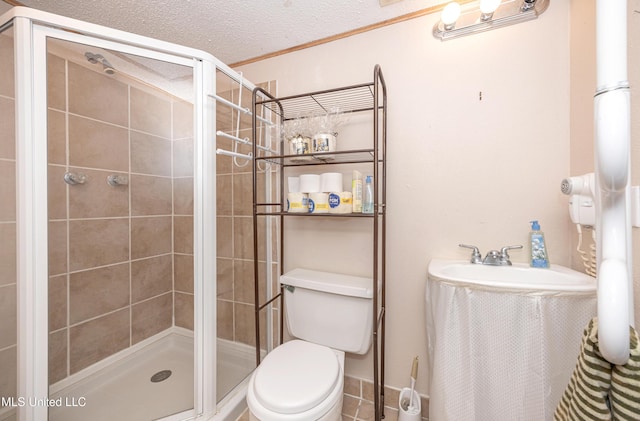 full bath with a textured ceiling, a shower stall, and toilet