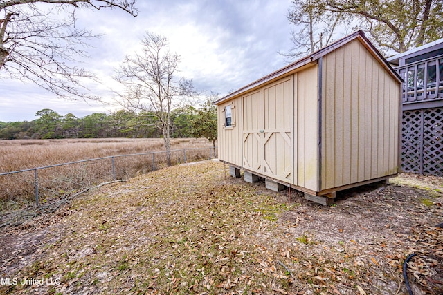 view of shed featuring fence