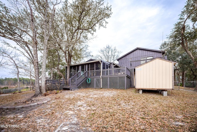 back of house with a sunroom, stairway, and a wooden deck