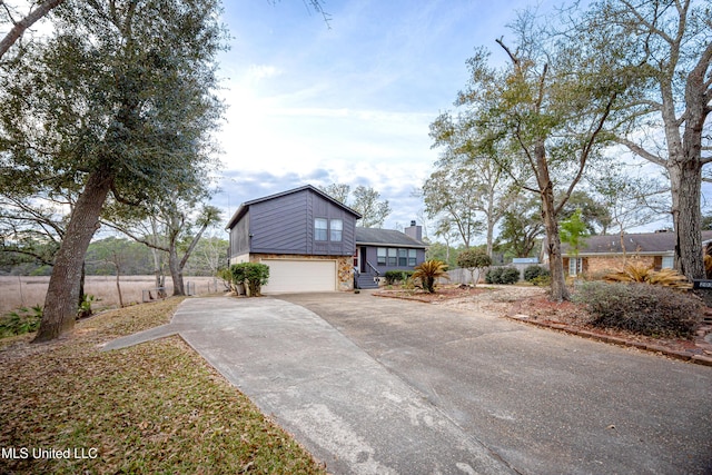 view of home's exterior featuring stone siding, driveway, and an attached garage