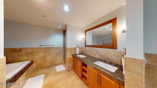 2060 Beach Blvd Unit 701, Biloxi, MS 39531 - full bath featuring double vanity, a garden tub, tile walls, an enclosed shower, and recessed lighting