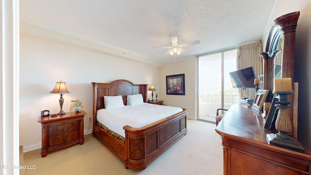 carpeted bedroom with a textured ceiling and ceiling fan