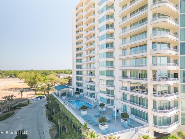 view of building exterior featuring a community pool