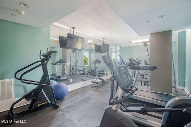 workout area with a textured ceiling