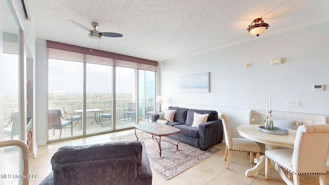 2060 Beach Blvd Unit 701, Biloxi, MS 39531 - living area with floor to ceiling windows, tile patterned floors, ceiling fan, and a textured ceiling