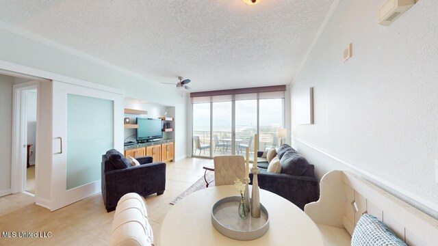 2060 Beach Blvd Unit 701, Biloxi, MS 39531 - living room featuring a textured ceiling, light tile patterned flooring, and ceiling fan