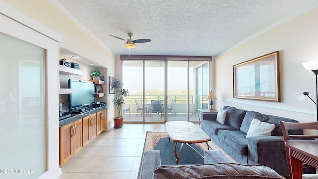 living room with ceiling fan, a textured ceiling, light tile patterned floors, and floor to ceiling windows