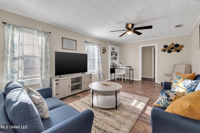 1264 28th St, Gulfport, MS 39501 - living area with a ceiling fan, wood finished floors, and ornamental molding