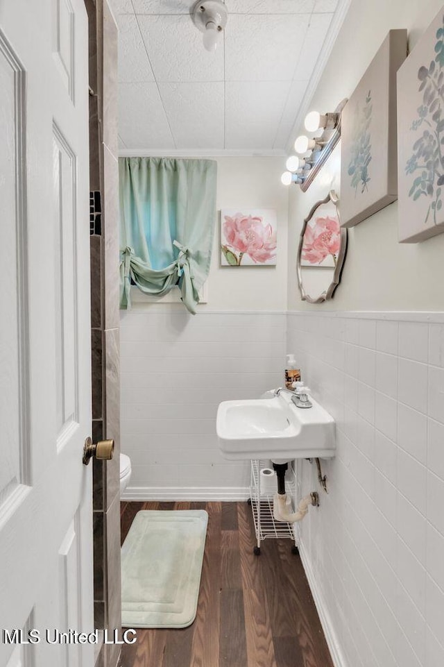 1264 28th St, Gulfport, MS 39501 - bathroom featuring toilet, a wainscoted wall, and wood finished floors