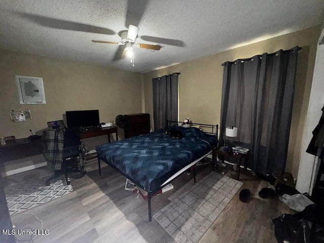 53 Flagstaff St, Lumberton, MS 39455 - bedroom featuring wood finished floors, a textured ceiling, and a ceiling fan