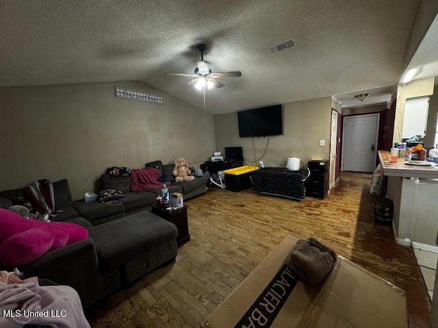 53 Flagstaff St, Lumberton, MS 39455 - living area featuring ceiling fan, wood finished floors, vaulted ceiling, and a textured ceiling