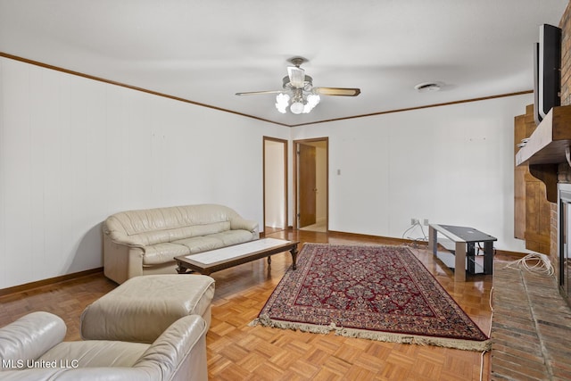 living area featuring a fireplace, crown molding, baseboards, and ceiling fan