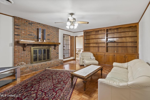 living area with ceiling fan, ornamental molding, and a brick fireplace