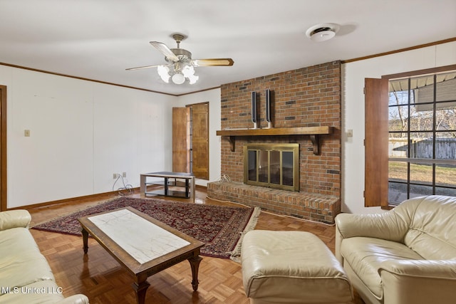 living area with ceiling fan, ornamental molding, a brick fireplace, and baseboards