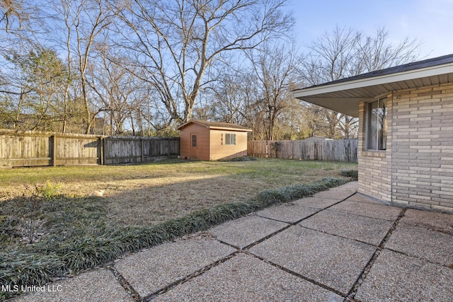 view of yard featuring an outbuilding, a storage shed, a patio area, and a fenced backyard