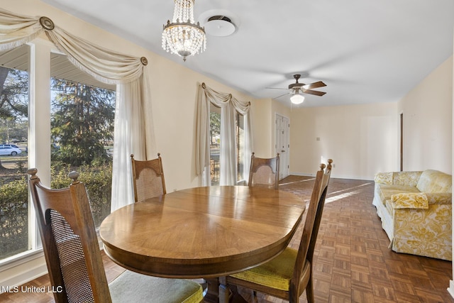 dining room featuring ceiling fan with notable chandelier