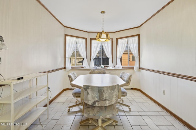 dining space featuring plenty of natural light, ornamental molding, and baseboards