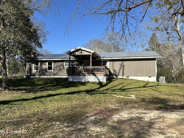 view of front of house with central AC, metal roof, a front lawn, and crawl space