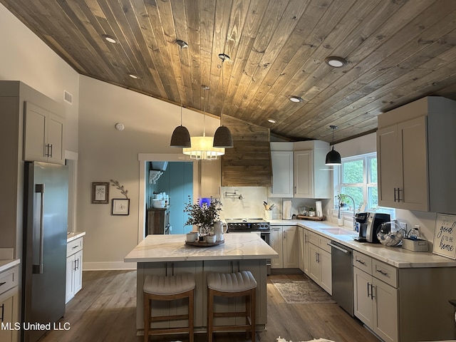 kitchen with custom exhaust hood, appliances with stainless steel finishes, dark wood-style flooring, and a center island