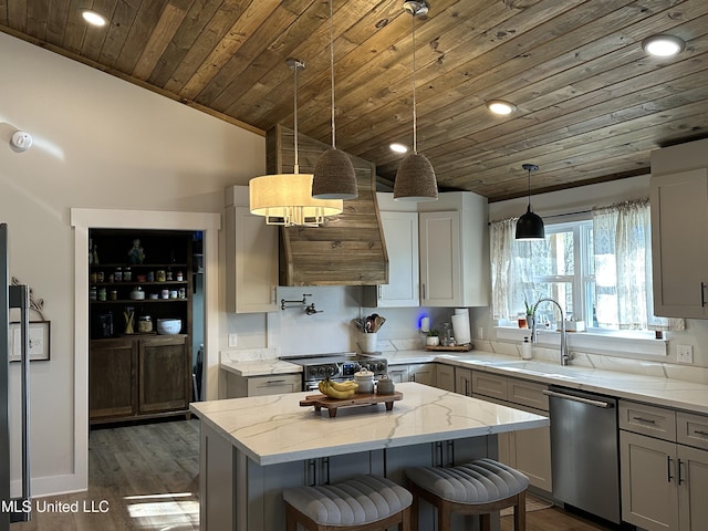 kitchen featuring dark wood finished floors, stainless steel appliances, wood ceiling, a kitchen island, and light stone countertops